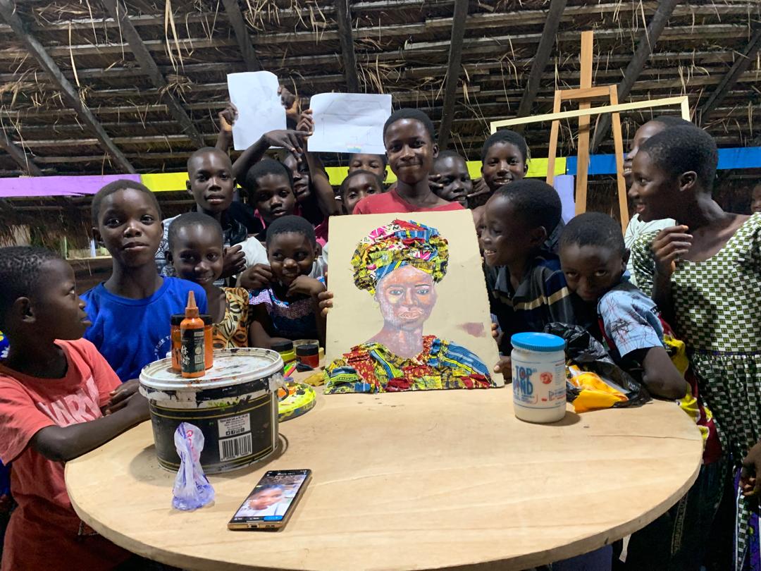 Children with books smiling outdoors